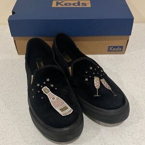 Keds Double Decker Cheers Black Slip-On Shoes with Champagne Embroidery